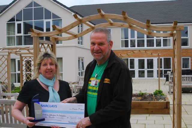 Holdingham Grange manager Hazel Whittaker presents the healthcare design award ?500 prize money to chosen charity, the Lincs and Notts Air Ambulance> It was accepted by volunteer and former recipient of its services, Mark Desmond. EMN-190103-173925001