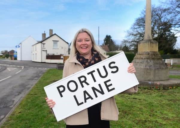 Steph Tilley of Chestnut Homes with one of the new road names, by the war memorial in Dunholme. EMN-190227-131638001