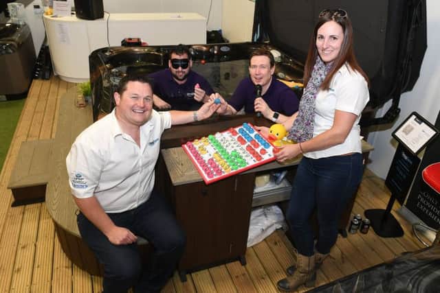 1Stop Spas, Billinghay. Tenth anniversary open event. Front Chris and Melissa Brady (owners) with Bubbling Bingo callers James Footitt and John Marshall of Lincs FM. EMN-190403-101928001