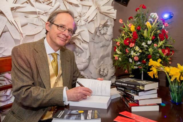 Nick Louth signs copies of his new book.