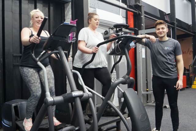 Apprentice personal trainer Kerim Djerbi with two of the gym users EMN-191203-074621001