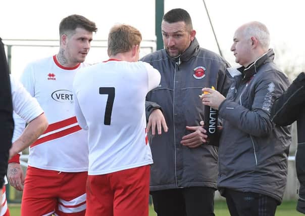 Nathan Collins and Nick Chapman, right, in discussion with the team on Saturday.