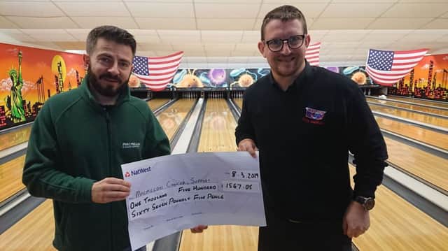 Jamie Davenport, Lincolnshires Macmillan Fundraising manager receives the cheque from Kevin Stephenson Assistant Manager of Skegness Bowl . ANL-191203-080029001