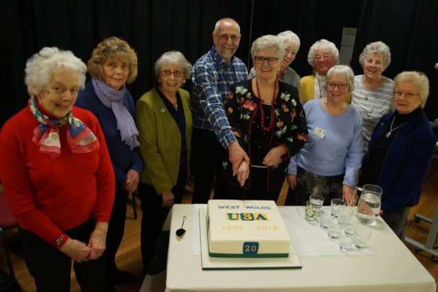 Former National Chair Pam Jones and West Wolds Chairman Steve McCarthy cut the cake watched by some of the founding and long-serving members EMN-190317-155244001