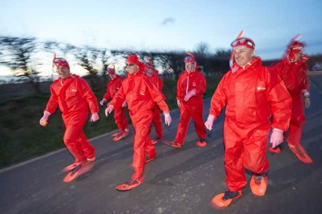 The management dressed up in red onesies