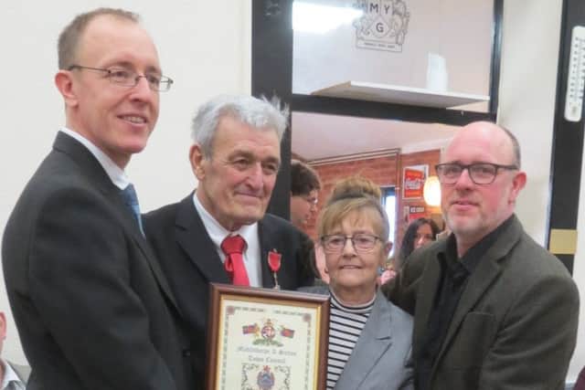John Monk MBE alongside his wife Maureen and sons Andrew and David.