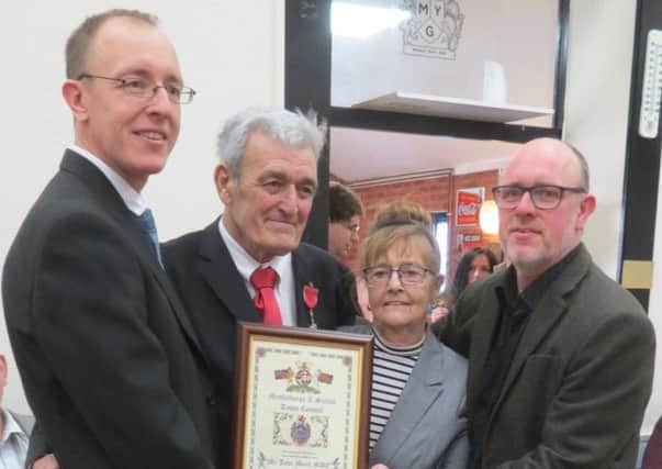 John Monk MBE alongside his wife Maureen and sons Andrew and David.
