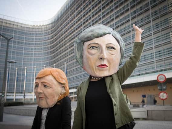 Anti Brexit protesters dressed as Theresa May and Angela Merkel outside the EU Commission in Brussels ahead of the European Leaders' summit at which Prime Minister Theresa May will be asking for an extension to Brexit. Picture: Stefan Rousseau/PA Wire