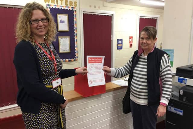 MRAG official June Clark hands the box over to Middle Rasen head teacher Rachel Moreton.