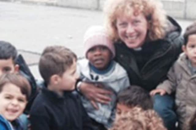 The Rev Christine Goldsmith pictured with some of the refugee children she supported.
