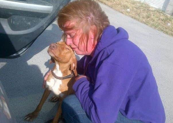 The Rev Christine Goldsmith with one of the dogs she rescued in Cyprus.