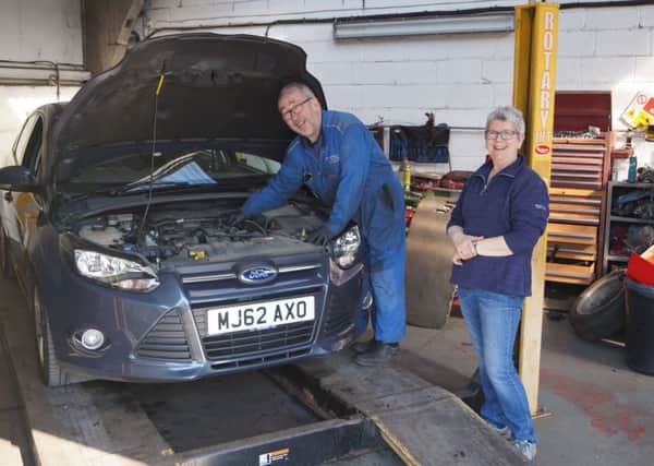 Jeff at work on the final car, watched by his wife Gill, who has done the book-keeping for the business EMN-190204-105711001