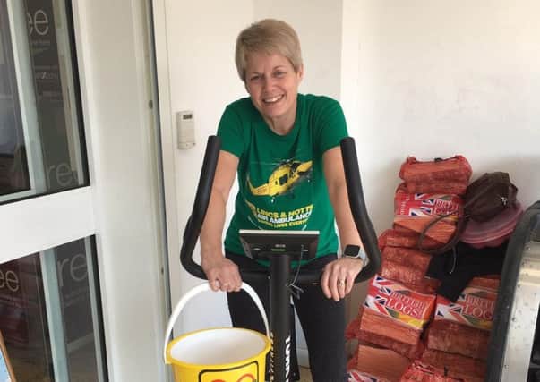 Sue Turner cycled at the  Co-Op Post Office branch in Market Rasen as part of her fundraising efforts. EMN-190104-133628001