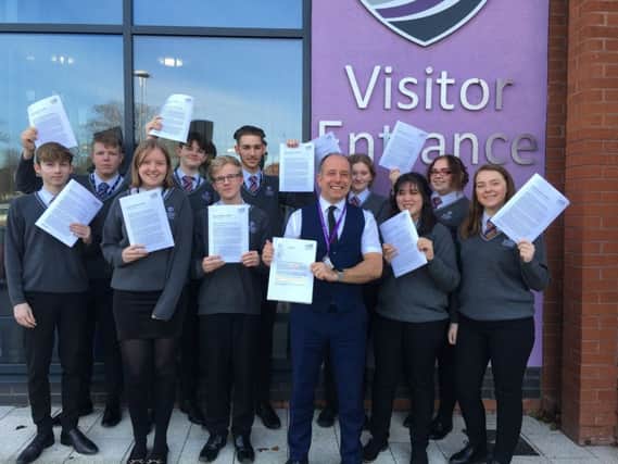 Principal Gary Carlile (right) with students celebrating a positive Ofsted report after a challenging period for Skegness Academy. ANL-190204-071309001