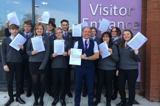 Principal Gary Carlile (right) with students celebrating a positive Ofsted report after a challenging period for Skegness Academy. ANL-190204-071309001