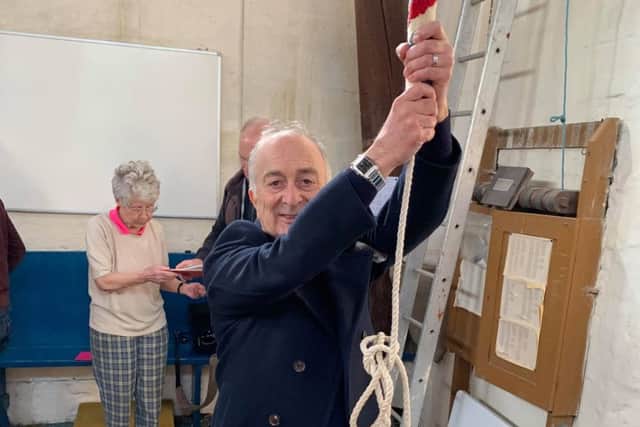 Sir Tony Robinson tries his hand a bell-ringing at St James Church.