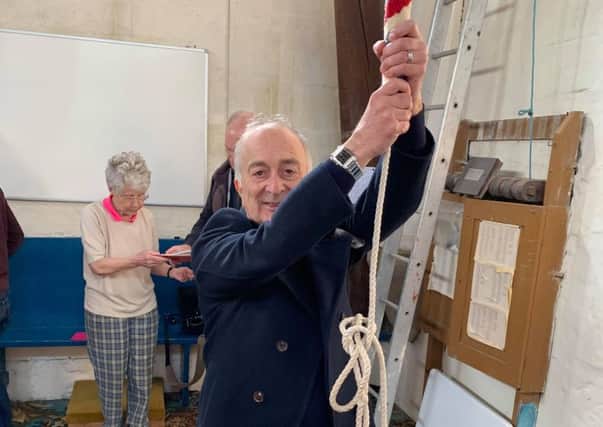 Sir Tony Robinson tries his hand a bell-ringing at St James Church.
