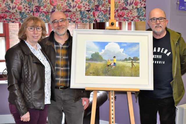 2018 Raffle winner Pauline Martin (left), husband Ian Martin and artist Dennis Nash (right) with painting.
