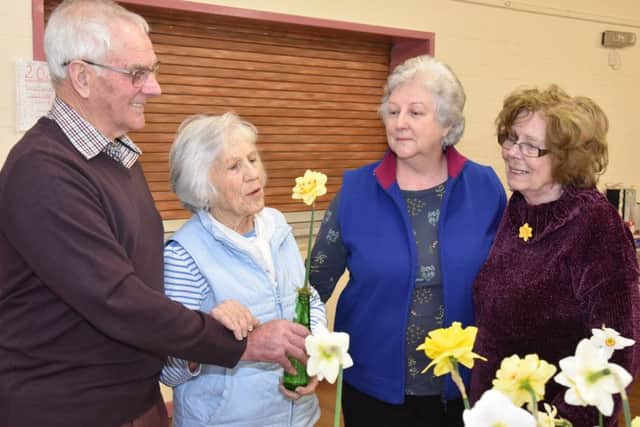 Daffodil judge Bill Parrott pointing out the finer points of a prize winning bloom to members Jean Thompson, Chairlady Chris Raynor and Sheila Minns. EMN-190404-163730001