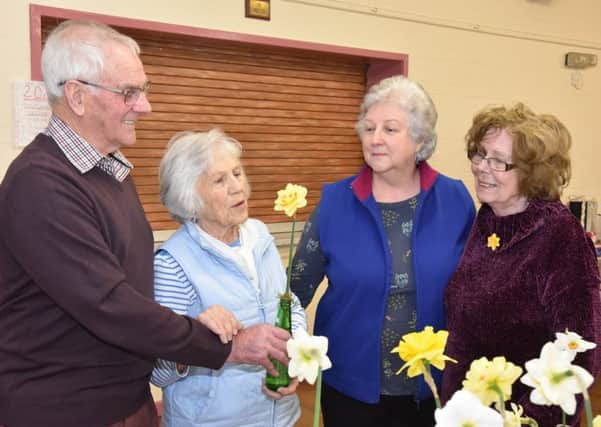 Daffodil judge Bill Parrott pointing out the finer points of a prize winning bloom to members Jean Thompson, Chairlady Chris Raynor and Sheila Minns. EMN-190404-163730001