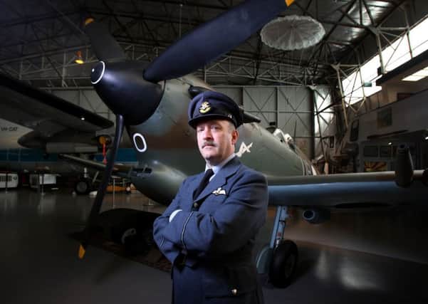 Nicholas Collett with a Spitfire fighter aeroplane at the South Australian Aviation Museum. Picture: Matt Turner.