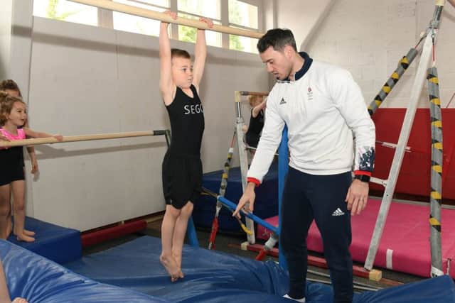 Sleaford Elite Gymnastics Club official opening of new premises with olympic gymnast Kristian Thomas and Spanish olympic trampolinist Humberto Hernandez. Kristian Thomas with Maximus Williams. EMN-190804-095833001