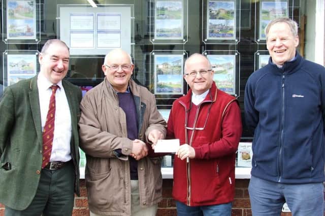 The cheque being presented by the Chairman of the Committee, Mike Harrison to the Rev Alan Robson on behalf of LRSN. Looking on are Richard Evison (Secretary) and Robert Bell (Treasurer). EMN-190416-095550001