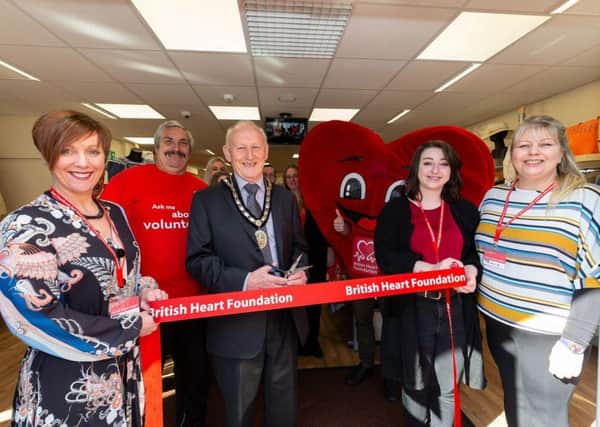 Mayor of Sleaford Coun Grenville Jackson cuts the ribbon to open the new British Heart Foundation shop in Sleaford. From left - (front) Maria Quirke (Store Manager), Christopher Stocks (volunteer) Coun Grenville Jackson (Mayor of Sleaford), Amelia Dobson (Assistant Manager at Sleaford) and Niki Elliott (Area Manager). EMN-191104-151628001