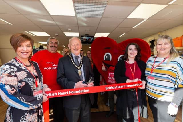 Mayor of Sleaford Coun Grenville Jackson cuts the ribbon to open the new British Heart Foundation shop in Sleaford. From left - (front) Maria Quirke (Store Manager), Christopher Stocks (volunteer) Coun Grenville Jackson (Mayor of Sleaford), Amelia Dobson (Assistant Manager at Sleaford) and Niki Elliott (Area Manager). EMN-191104-151628001