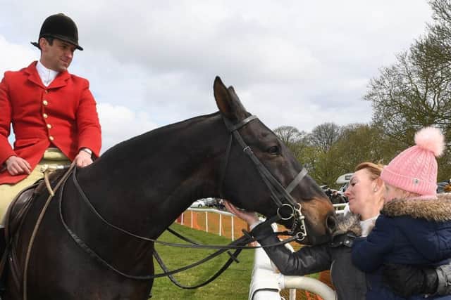 South Wold huntsman Adam Essom with Lisa Ranganathan and Sophie Ranganathan, three, of Butterwick.