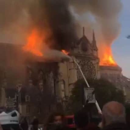 Image taken from the Twitter feed of @AshhHuntington of smoke and flames coming from the roof of Notre Dame Cathedral in Paris. Photo: Ashley Huntington/Mercedes Girona/PA WireEMN-190417-155629001