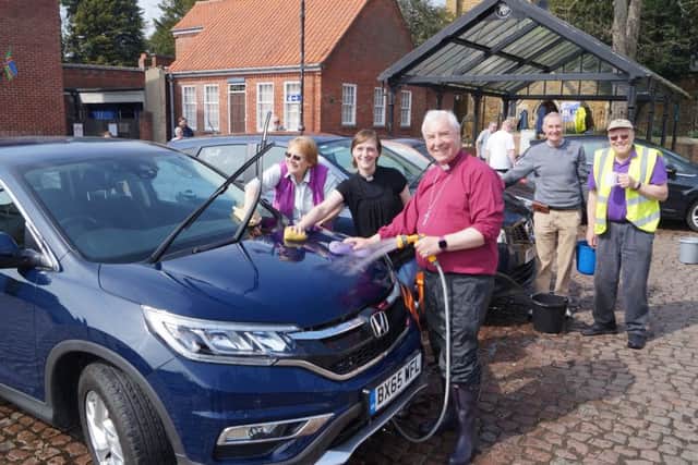 The Bishop of Lincoln turned out to wash cars in Market Rasen market place last week EMN-190423-105304001