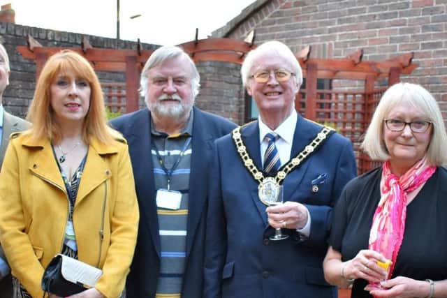 Mayor of North Lincolnshire John Briggsand artist Lynda Houghton are pictured with members of the Lindsey Lodge Hospice Senior Management Team and Board of Trustees at the Art Exhibition and Sale. EMN-190425-105750001
