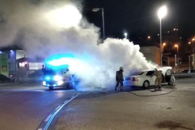 Firefighters tackle the blazing Mercedes. (Photo Joseph Hayat.) EMN-190430-092605001