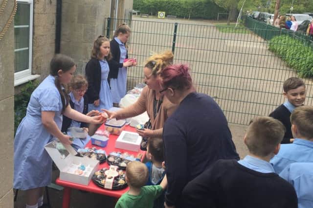 Rauceby School councillors and ambassadors holding the fundraising bake sale to help a school in Gainsborough targeted by thieves who stole their chickens. EMN-190430-105755001