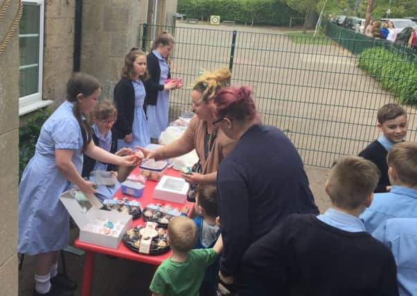 Rauceby School councillors and ambassadors holding the fundraising bake sale to help a school in Gainsborough targeted by thieves who stole their chickens. EMN-190430-105755001