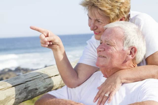 Elderly couple on the beach (stock image)