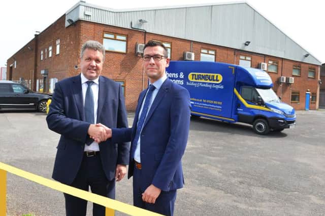Turnbull Director Chris Hopkins (left) and William Wall, director of Banks Long & Co which has jointly handled the lease with Lambert Smith Hampton, outside Turnbull's new Lincoln premises.