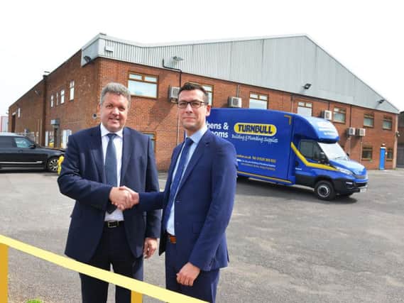 Turnbull Director Chris Hopkins (left) and William Wall, director of Banks Long & Co which has jointly handled the lease with Lambert Smith Hampton, outside Turnbull's new Lincoln premises.