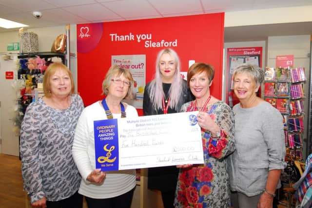 Sleaford and District Lionesses present the money to British Heart Foundation managers at the new sleaford charity shop in Southgate. EMN-190205-110538001