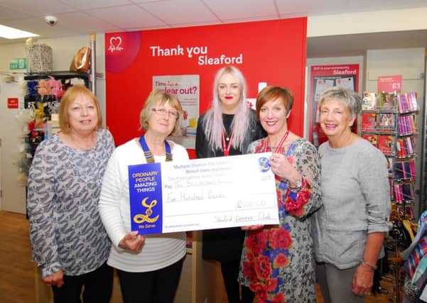 Sleaford and District Lionesses present the money to British Heart Foundation managers at the new sleaford charity shop in Southgate. EMN-190205-110538001