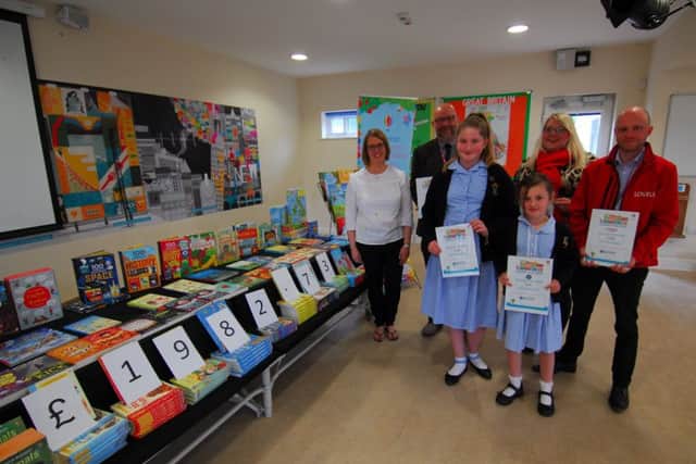 Pictured from left with Rauceby School children and the books are - Sarah Singleton of Usborne Books, Paul Roberts of Turnbulls, Hannah Mountcastle of Sleafordian Coaches and Dan Osborne of Lovells. EMN-190205-125446001