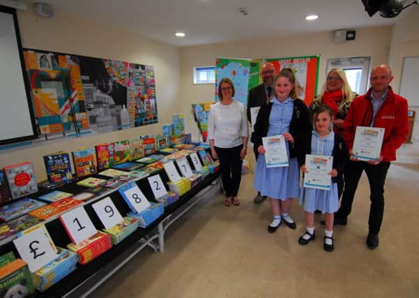 Pictured from left with Rauceby School children and the books are - Sarah Singleton of Usborne Books, Paul Roberts of Turnbulls, Hannah Mountcastle of Sleafordian Coaches and Dan Osborne of Lovells. EMN-190205-125446001