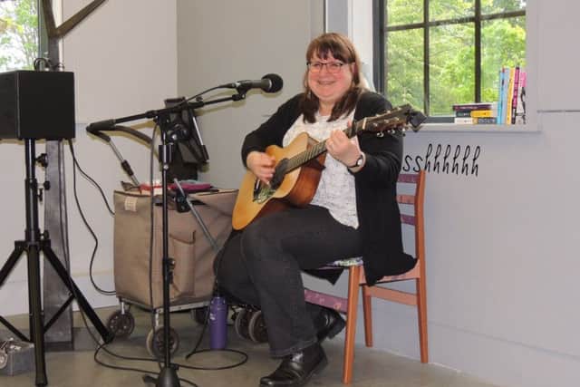 American singer/songwriter Lynn McFarland busking in the NCCD exhibition on Saturday. EMN-190605-124816001