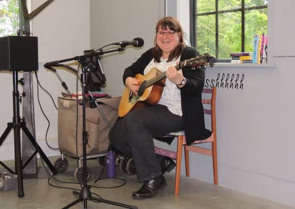 American singer/songwriter Lynn McFarland busking in the NCCD exhibition on Saturday. EMN-190605-124816001