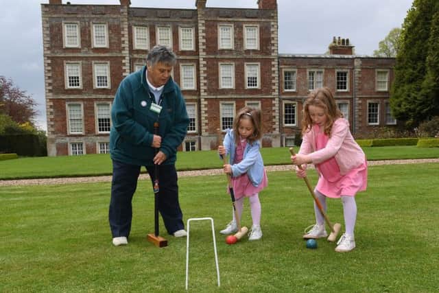 Glynis Docker demonstrating Garden Croquet to L-R Charlotte Berry 4 and Louisa Berry 5. EMN-190705-092544001