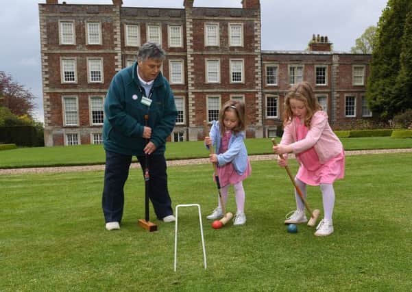 Glynis Docker demonstrating Garden Croquet to L-R Charlotte Berry 4 and Louisa Berry 5. EMN-190705-092544001