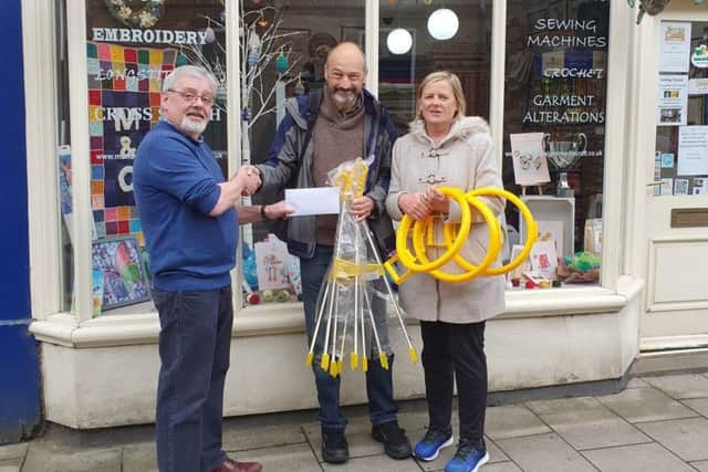 Gary Denniss hands over the cheque to the Litter Free Louth group.