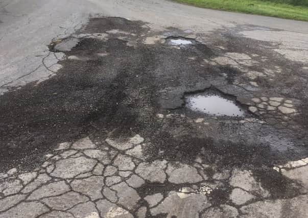 Craig Wood has complained that potholes are being ignored in Burton Pedwardine, but county councillor Martin Hill says they have to prioritise spending. EMN-190513-172605001