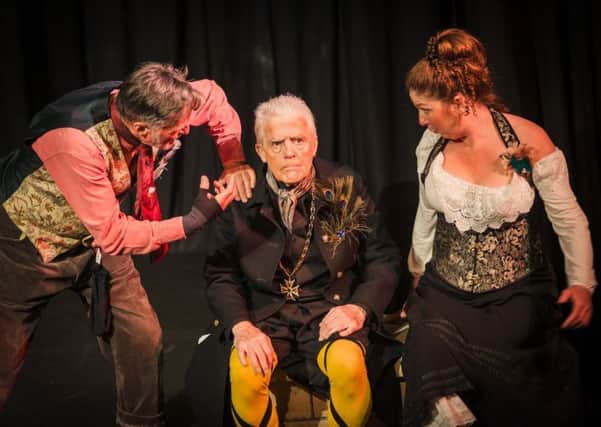 Very fetching in yellow stockings and crossed garters. Paul Sproxton as Malvolio with his tormentors Tony Gordon as Sir Toby Belch and Caroline Johnson as Maria. EMN-191005-110645001
